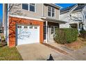 Attached garage with white door and brick facade at 105 Danesway Dr, Holly Springs, NC 27540