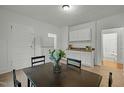 Dining room with table and chairs, white cabinets, and adjacent rooms visible at 1108 Taylor St, Durham, NC 27701