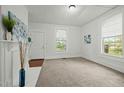 Bright living room with a fireplace, neutral carpet, white walls, and natural light from the windows at 1108 Taylor St, Durham, NC 27701
