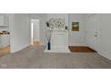 Charming living room with a decorative fireplace, plush carpet, and white wood paneled walls at 1108 Taylor St, Durham, NC 27701