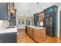 Modern kitchen with two-toned cabinetry, granite countertops, and large island at 113 Meadowglades Ln, Cary, NC 27518