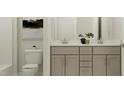 Modern bathroom with double vanity and a toilet at 1528 Goldfinch Perch Ln, Knightdale, NC 27545