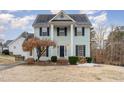 Two-story light green house with a brick walkway and landscaping at 2047 Ferbow St, Creedmoor, NC 27522