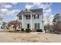 Two-story light green house with a brick walkway and landscaping at 2047 Ferbow St, Creedmoor, NC 27522