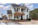 Two-story light green house with a brick walkway and landscaping at 2047 Ferbow St, Creedmoor, NC 27522
