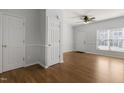 Inviting living room with hardwood floors, large windows, and neutral paint at 3 Cheltenham Dr, Clayton, NC 27520