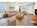 Virtually staged living room with beige couch and wooden coffee table at 3113 Skybrook Ln, Durham, NC 27703