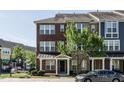 Three-story townhome with brick facade and landscaping at 332 Dove Cottage Ln, Cary, NC 27519