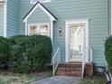 Front entrance of townhome featuring brick steps and green siding at 431 Oak Run Dr, Raleigh, NC 27606