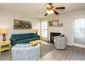 Living room with teal sofa, fireplace, and wood-look flooring at 431 Oak Run Dr, Raleigh, NC 27606