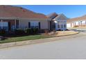 Tan brick home with a sunroom and attached garage at 4712 Fox Fern Ln, Raleigh, NC 27604