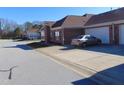Side view of home showcasing attached garage and driveway at 4712 Fox Fern Ln, Raleigh, NC 27604