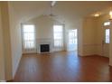 Spacious living room with hardwood floors, fireplace, and sunroom access at 4712 Fox Fern Ln, Raleigh, NC 27604