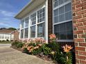 The sunroom features large windows and a vibrant flower garden at 4712 Fox Fern Ln, Raleigh, NC 27604