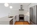 Bright kitchen featuring white countertops, stainless steel appliances, and modern pendant lighting at 523 S West # 305, Raleigh, NC 27601