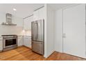 Modern kitchen featuring stainless steel appliances, white cabinets, and wood flooring at 523 S West # 305, Raleigh, NC 27601
