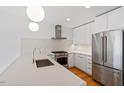 Well-lit kitchen featuring stainless steel appliances, white countertops, and modern lighting at 523 S West # 305, Raleigh, NC 27601