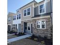 Inviting townhouse exteriors with stone accents, horizontal siding and manicured lawns at 6328 Granite Quarry Dr, Raleigh, NC 27610