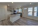 Modern kitchen with gray cabinets, granite countertops, stainless appliances and island at 6328 Granite Quarry Dr, Raleigh, NC 27610