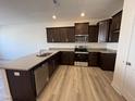 Kitchen features granite counters, stainless appliances and sleek, dark cabinetry at 6330 Granite Quarry Dr, Raleigh, NC 27610