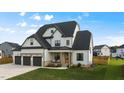 Stunning two-story home with white siding, dark roof, and a three-car garage at 1105 Duke Farm Dr, Wake Forest, NC 27587