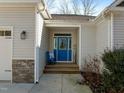 Inviting home entrance featuring a bright blue door and charming decor at 1119 Sagamore Dr, Louisburg, NC 27549