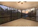 A screened porch provides peaceful outdoor living with sunset lake views at 1119 Sagamore Dr, Louisburg, NC 27549