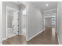 Bright hallway with hardwood floors, leading to bathroom and bedroom at 1177 St. Cloud Loop, Apex, NC 27523