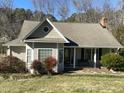 Charming single-story home with a manicured front yard and covered porch with bench at 1508 Woods Creek Dr, Garner, NC 27529