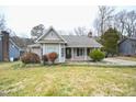 Charming single-story home with a manicured front yard and covered porch with bench at 1508 Woods Creek Dr, Garner, NC 27529