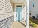 Charming light blue front door with stone accents and crisp white trim on a well-maintained home at 168 Begonia St, Angier, NC 27501