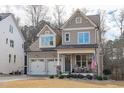 Two-story house with a two-car garage and welcoming front porch at 2224 Madison Creek Dr, Apex, NC 27502