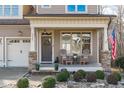Inviting front porch with seating and American flag at 2224 Madison Creek Dr, Apex, NC 27502