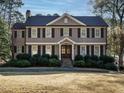 Charming two-story home with a manicured lawn, mature trees, and classic architectural details at 505 Annandale Dr, Cary, NC 27511