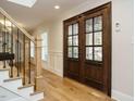 Elegant foyer with hardwood floors, wainscoting, and a staircase with wrought iron railings at 505 Annandale Dr, Cary, NC 27511