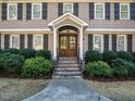 Inviting front entrance with stone steps, a covered porch, and a beautifully crafted wooden door at 505 Annandale Dr, Cary, NC 27511