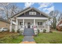 Charming craftsman style home with a front porch and well-manicured lawn at 607 Young St, Henderson, NC 27536