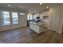 Bright kitchen featuring a granite island, stainless appliances, and hardwood floors at 6332 Granite Quarry Dr, Raleigh, NC 27610