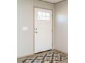 Front entry with white door, wood flooring and patterned rug at 6545 Old Jefferson Davis Hwy, Cameron, NC 28326