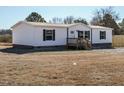 Front view of a white manufactured home with a small deck at 6567 Old Jefferson Davis Hwy, Cameron, NC 28326