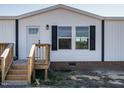 Close-up of the front entrance of a white manufactured home at 6567 Old Jefferson Davis Hwy, Cameron, NC 28326