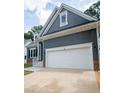 Gray house with white garage door and brick base at 105 Tracey Creek Ct Ct, Apex, NC 27502