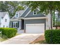 Gray house with white garage door and landscaping at 105 Tracey Creek Ct Ct, Apex, NC 27502
