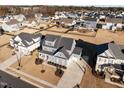 Aerial view showing a large home with a basketball court in a neighborhood at 1188 Duke Farm Dr, Wake Forest, NC 27587