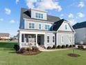 Beautiful two-story home with gray siding, white trim, and a manicured lawn at 1188 Duke Farm Dr, Wake Forest, NC 27587