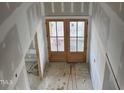 Double front doors leading into the foyer of a new home at 1401 Cottondale Ln, Wake Forest, NC 27587