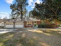 House exterior showcasing a brick facade, two-car garage, and landscaping at 1501 Mountain View Ct, Hillsborough, NC 27278