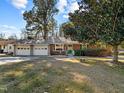 Front view of a ranch house with a two-car garage and mature trees at 1501 Mountain View Ct, Hillsborough, NC 27278