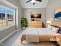 Virtually staged bedroom with large window and wood flooring at 1813 Ferrell Meadows Dr, Zebulon, NC 27597