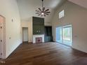 Spacious living room with hardwood floors, a decorative fireplace, built-in shelving, and sliding glass doors to the outside at 20 Tamaran Ct, Spring Hope, NC 27882
